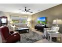 Comfortable living room featuring neutral tones, plush seating, and a large window with a view at 15501 W Las Verdes Way, Surprise, AZ 85374