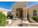 Close-up of the front entrance showcasing the arched entryway, detailed columns, and a well-maintained walkway at 15803 E Tumbleweed Dr, Fountain Hills, AZ 85268