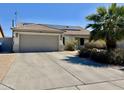 Charming single-story home with a two-car garage, solar panels, and desert landscaping at 16243 N 27Th St, Phoenix, AZ 85032