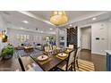 Elegant dining room with modern lighting, stylish decor, and an open floor plan perfect for entertaining at 17505 N 96Th Way, Scottsdale, AZ 85255