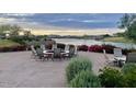 Outdoor patio seating area with a fire pit and water views at 18105 W Hiddenview Dr, Goodyear, AZ 85338