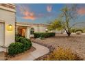 Inviting walkway leading to the front entrance with desert landscaping and mature trees at 18833 E Latigo Ln, Rio Verde, AZ 85263