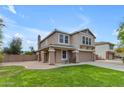 This charming two-story home features a stucco exterior, attached two-car garage, and well-manicured lawn at 2501 E Los Alamos St, Gilbert, AZ 85295