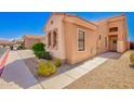 Exterior view of a single story home with stone facade, desert landscaping, and sidewalk at 2565 S Signal Butte Rd # 8, Mesa, AZ 85209