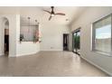 Spacious living room featuring tile floors, a ceiling fan, and a sliding glass door at 2565 S Signal Butte Rd # 8, Mesa, AZ 85209