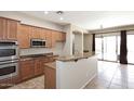 Well-equipped kitchen with stainless steel appliances, granite counters and a breakfast bar at 3223 W Rapalo Rd, Phoenix, AZ 85086