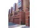 Townhouse garages with brick facade, offering convenient parking and storage options at 330 S Farmer Ave # 121, Tempe, AZ 85281