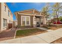 Attractive home with tidy landscaping and a cozy front porch sitting area at 4061 N Point Ridge Rd, Buckeye, AZ 85396