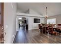 Open concept dining room with wood floors and decorative lighting fixture at 4440 W Fallen Leaf Ln, Glendale, AZ 85310