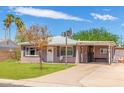 Lovely single-story home with a manicured front lawn and covered carport at 4512 E Turney Ave, Phoenix, AZ 85018