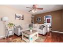 Inviting living room with a large sectional sofa, stylish decor, and rich hardwood floors at 4512 E Turney Ave, Phoenix, AZ 85018