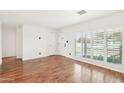 Bright living room featuring wood floors, shuttered windows and white walls at 5307 E Cambridge Ave, Phoenix, AZ 85008