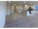 Inviting living space with a seamless transition to the kitchen, featuring sleek tile and cozy carpet flooring at 6078 E Artemis Dr, Florence, AZ 85132