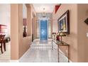 Bright entryway featuring tile flooring, a blue front door, and decorative accents at 6531 E Star Valley St, Mesa, AZ 85215