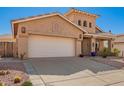 Tan home with a white garage door and desert landscaping is displayed at 6531 E Star Valley St, Mesa, AZ 85215