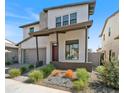 Charming two-story home showcasing a modern design, covered entry, and professionally landscaped front yard at 6735 N 9Th Dr, Phoenix, AZ 85013