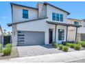Beautiful two-story home showcasing a gray garage door, and low maintenance landscaping at 6735 N 9Th Dr, Phoenix, AZ 85013