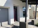 Close-up of a modern front porch with gray pavers and a sleek, contemporary design at 6735 N 9Th Dr, Phoenix, AZ 85013