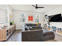 Cozy living room featuring a large sectional sofa, modern decor, and bright natural light at 741 N Abalone Ct, Gilbert, AZ 85233