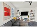 Inviting living room with modern decor, a large flat screen TV, and contemporary shelving at 741 N Abalone Ct, Gilbert, AZ 85233