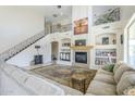 Spacious living room featuring a fireplace, high ceilings, elegant staircase, and lots of decor at 7421 S 25Th Ln, Phoenix, AZ 85041