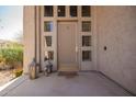 Inviting entryway with a decorative door, sidelights, and charming lanterns at 7693 E Via Del Sol Dr, Scottsdale, AZ 85255