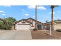 Charming single-story home with a well-manicured lawn and a two-car garage at 8762 W Grovers Ave, Peoria, AZ 85382