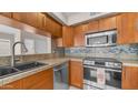 Updated kitchen with stainless steel appliances, ample counter space, and modern sink fixtures at 8762 W Grovers Ave, Peoria, AZ 85382