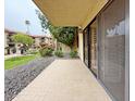 View from patio showing lawn, walkway, and condo building with tiled roof at 10330 W Thunderbird Blvd # B101, Sun City, AZ 85351