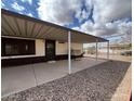 Large covered back patio with concrete flooring, offering ample space for outdoor living and entertaining at 10997 N Hualapai Dr, Casa Grande, AZ 85122
