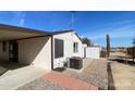 Exterior showcasing an AC unit, storage shed, desert landscape, and covered patio at 10997 N Hualapai Dr, Casa Grande, AZ 85122