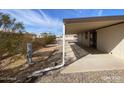 Side view of a covered patio extending along a home's exterior, offering shade and outdoor living space at 10997 N Hualapai Dr, Casa Grande, AZ 85122