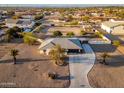 Aerial view of a desert home with mature landscaping and a long driveway in a quiet community at 11138 W Hatcher Rd, Sun City, AZ 85351