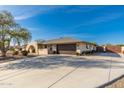 Attractive house with brick archway, desert landscaping, two-car garage, and gated RV parking at 11138 W Hatcher Rd, Sun City, AZ 85351