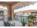 Outdoor balcony area with beautiful plants, cozy seating, and great views from the apartment building at 11640 N Tatum Blvd # 3074, Phoenix, AZ 85028