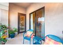 Apartment balcony with cozy seating and beautiful door leading to indoor living space at 11640 N Tatum Blvd # 3074, Phoenix, AZ 85028