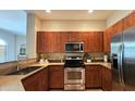 Well-equipped kitchen features stainless steel appliances, wooden cabinets, and beautiful granite countertops at 11640 N Tatum Blvd # 3074, Phoenix, AZ 85028