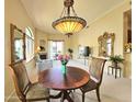 Elegant living room with fireplace, ornamental mirror, and statement lighting at 11640 N Tatum Blvd # 3074, Phoenix, AZ 85028