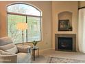 Bright living room with large windows, fireplace, and comfortable seating area at 11640 N Tatum Blvd # 3074, Phoenix, AZ 85028