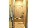 Modern shower with glass door, stone flooring, and convenient showerhead at 11640 N Tatum Blvd # 3074, Phoenix, AZ 85028