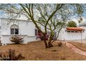 Charming home showcasing terra cotta roof, decorative iron gate, and a well-manicured, low-maintenance yard at 120 E Calavar Rd, Phoenix, AZ 85022