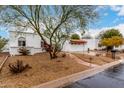 Charming home showcasing terra cotta roof, decorative iron gate, and a well-manicured, low-maintenance yard at 120 E Calavar Rd, Phoenix, AZ 85022