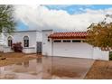 Charming home showcasing terra cotta roof, arched window, and an attached garage at 120 E Calavar Rd, Phoenix, AZ 85022