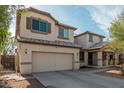 Charming two-story home with a well-manicured lawn and a two-car garage at 12509 W Whyman St, Avondale, AZ 85323