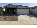 Charming single-story home with a two-car garage and desert landscaping, and a covered porch entry at 13179 E Verbina Ln, Florence, AZ 85132