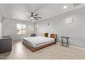 Spacious main bedroom featuring neutral walls, ceiling fan, tile floors, and a bright window at 1409 E Verlea Dr, Tempe, AZ 85282