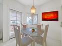 Cozy dining area with a glass table, four chairs, and a view of the outdoors at 145 N 74Th St # 256, Mesa, AZ 85207