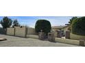 Exterior view of front gate, rock decorations, manicured shrubs, and house address at 18224 N 70Th Ave, Glendale, AZ 85308