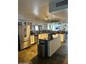 Spacious kitchen with stainless steel appliances, white cabinets, and a center island at 18224 N 70Th Ave, Glendale, AZ 85308