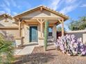 Inviting front porch with desert landscaping and a comfortable seating area at 18556 W Vogel Ave, Goodyear, AZ 85338